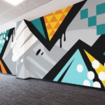 A vibrant wall mural featuring geometric shapes and colors, promoting digital education accessibility.