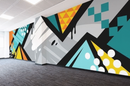 A vibrant wall mural featuring geometric shapes and colors, promoting digital education accessibility.