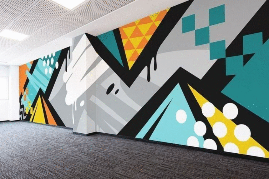 A vibrant wall mural featuring geometric shapes and colors, promoting digital education accessibility.